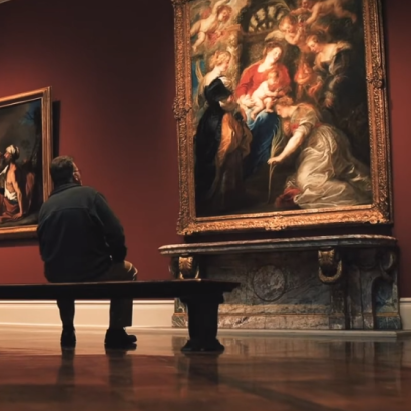 man looking at art