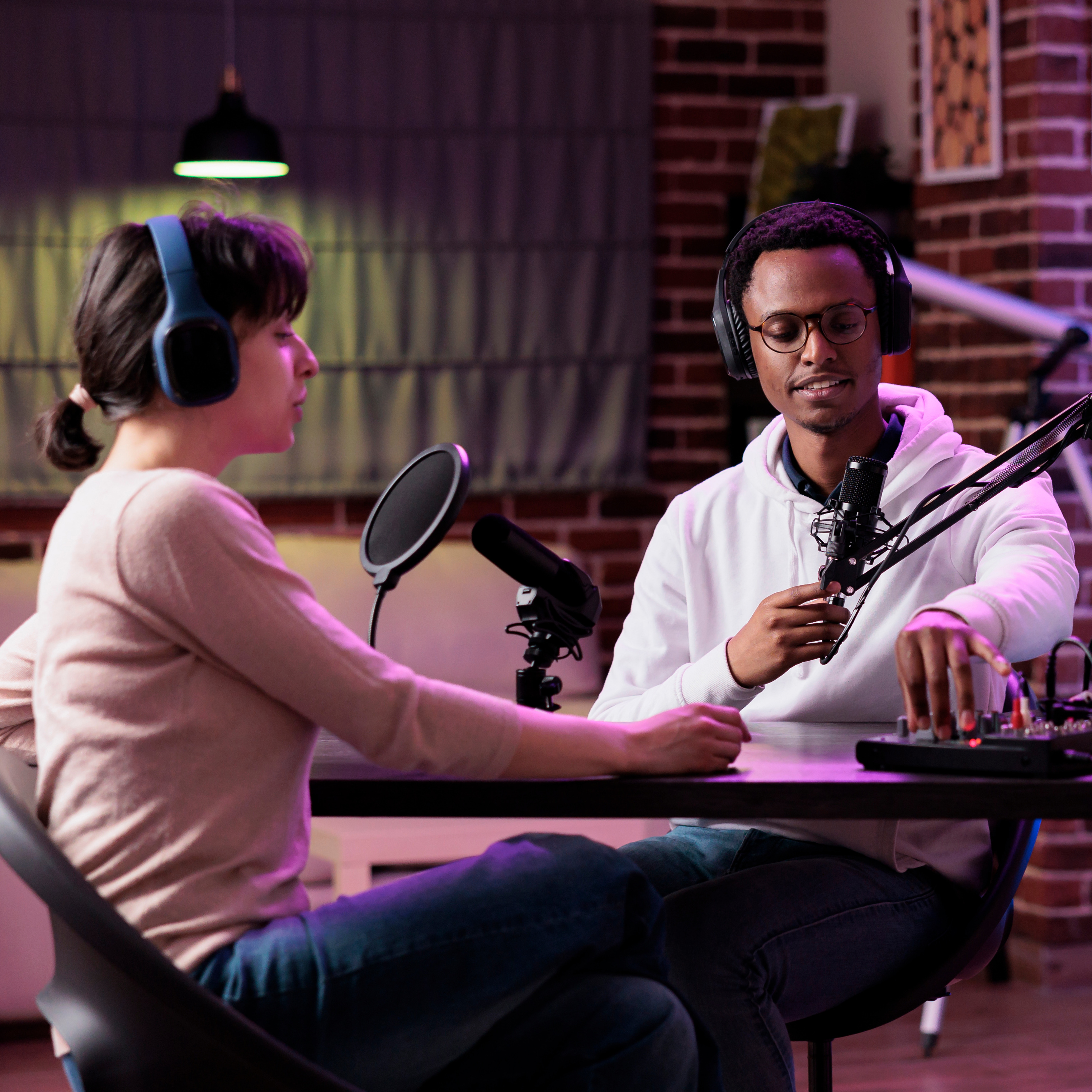 two people talking into microphone